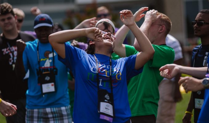 youth in brightly colored shirts celebrate joyfully