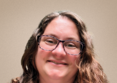 Headshot of Lauren, smiling and wearing a blue shirt.