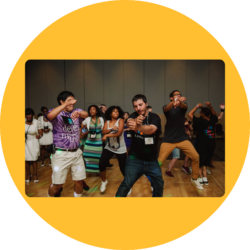 Photo of youth participants dancing at the youth social during a Youth & Family Summit.