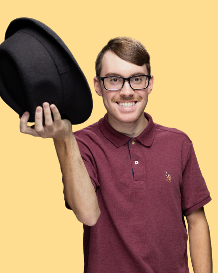 Headshot of youth leader, Nick, tipping a hat.